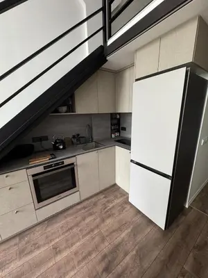 a kitchen with a white refrigerator and a sink at Locusdo Apartment Nr 32 in Vilnius