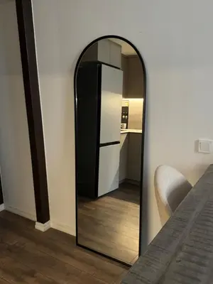 a mirror in the corner of a room with a refrigerator at Locusdo Apartment Nr 32 in Vilnius