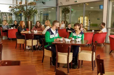 a group of people sitting at tables in a restaurant at Medical SPA 