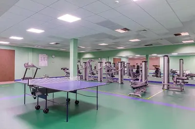 a gym with a ping pong table in the middle at Medical SPA 