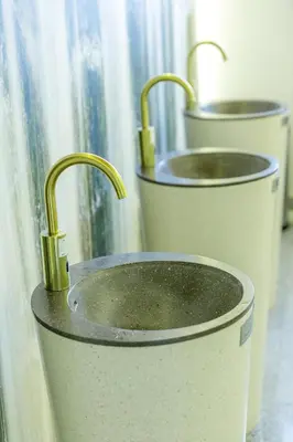 two metal buckets with gold faucets in a window at Medical SPA 