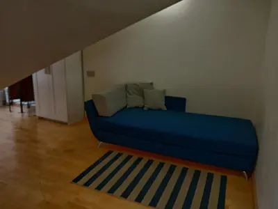a blue couch sitting in a living room at Spacy apartment on Laisves avenue in Kaunas