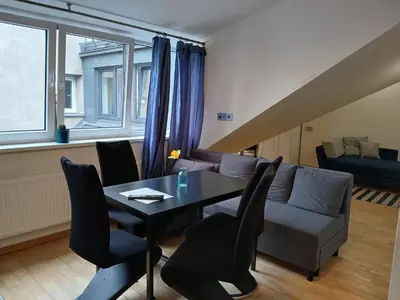 a living room with a table and a couch at Spacy apartment on Laisves avenue in Kaunas