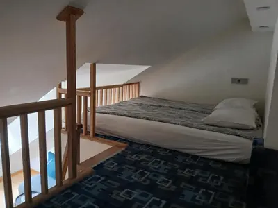 a bedroom with a bed in a attic at Spacy apartment on Laisves avenue in Kaunas