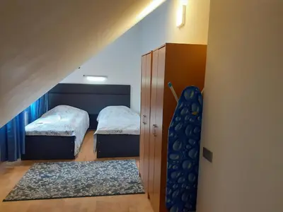 a small room with two beds and a staircase at Spacy apartment on Laisves avenue in Kaunas