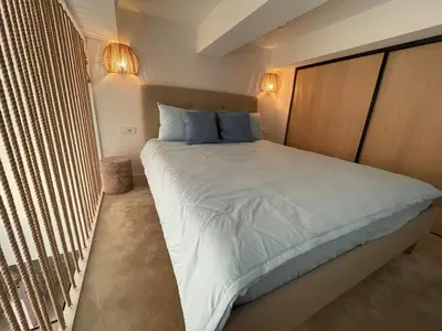 a bedroom with a large white bed with blue pillows at Lovely new loft in Vilnius centre self-check in in Vilnius