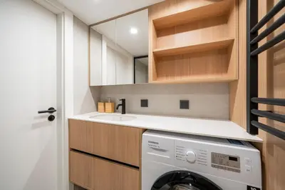 a laundry room with a washing machine and a sink at Lovely new loft in Vilnius centre self-check in in Vilnius