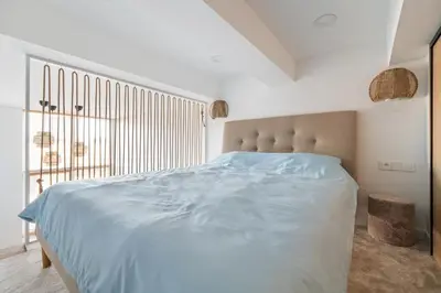 a white bedroom with a large bed and a window at Lovely new loft in Vilnius centre self-check in in Vilnius