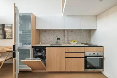a kitchen with white cabinets and a sink at Lovely new loft in Vilnius centre self-check in in Vilnius