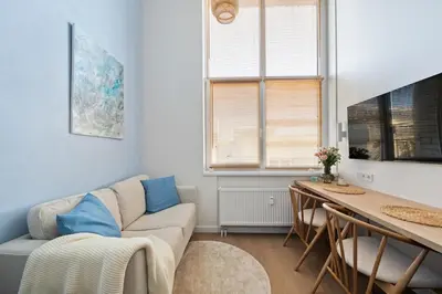 a living room with a couch and a table at Lovely new loft in Vilnius centre self-check in in Vilnius