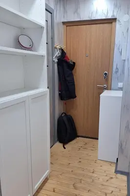 a room with a door and a backpack next to a door at Cozy studio apartment in Marijampolė