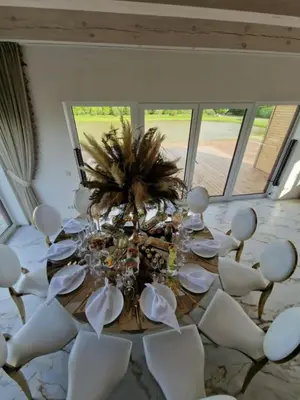 a dining room with a table and white chairs at Modern design in quiet nature