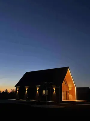 a building with lights on the side of it at Modern design in quiet nature