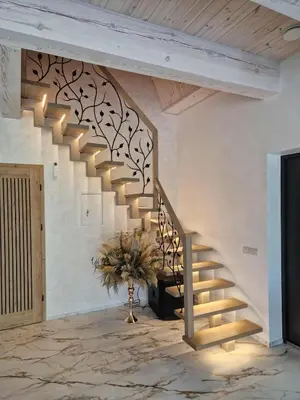 a staircase in a living room with a plant at Baltasis beržas