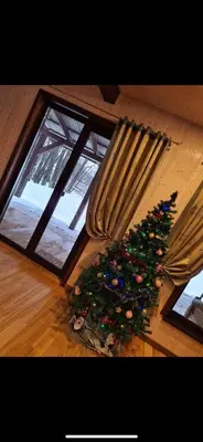 a christmas tree sitting on the floor next to a window at Čičirio krantas in Vėdariai