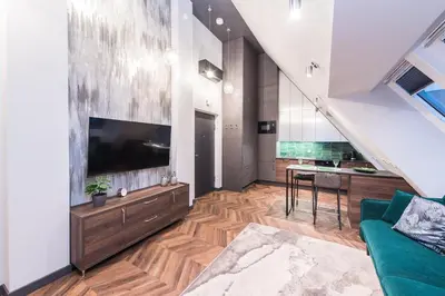 a living room with a large tv and a couch at Modern I Penthouse Apt w - AC I Cohost in Vilnius