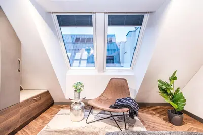 a room with a chair and a window at Modern I Penthouse Apt w - AC I Cohost in Vilnius