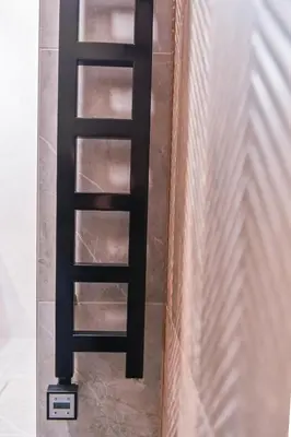 a black ladder on the floor next to a wall at Modern I Penthouse Apt w - AC I Cohost in Vilnius