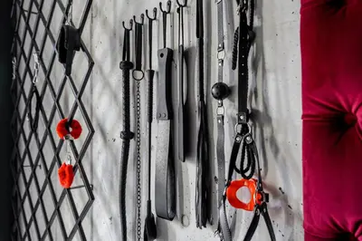a bunch of knives hanging on a wall at 69 Fetish Apartments with Free Underground Parking in Kaunas