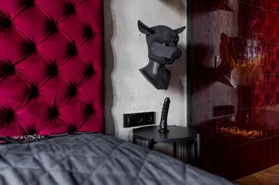 a bedroom with a bed with a pink head board at 69 Fetish Apartments with Free Underground Parking in Kaunas