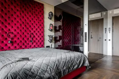 a bedroom with a red wall and a bed at 69 Fetish Apartments with Free Underground Parking in Kaunas