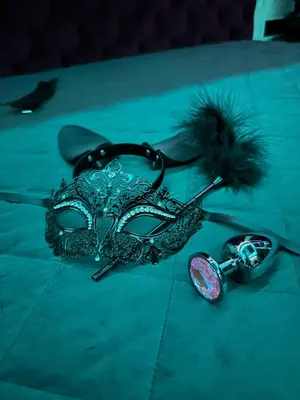 a mask and a pair of keys on a table at 69 Fetish Apartments with Free Underground Parking in Kaunas