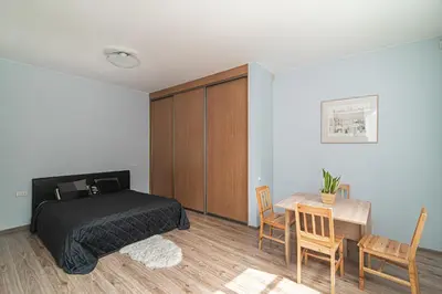 a bedroom with a bed and a table and chairs at Old Town Peace Haven in Vilnius