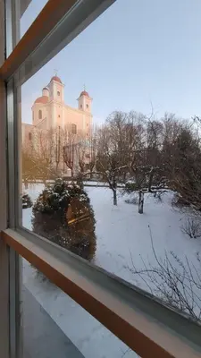 a window view of a building in the snow at Old Town Peace Haven in Vilnius