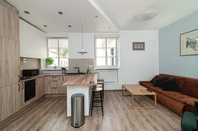 a kitchen and living room with a couch and a table at Old Town Peace Haven in Vilnius