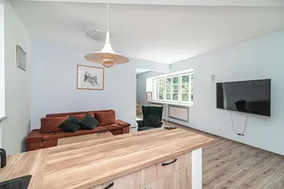 a living room with a couch and a flat screen tv at Old Town Peace Haven in Vilnius