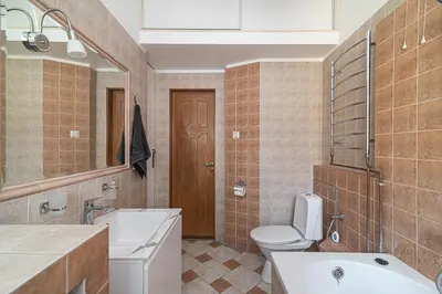 a bathroom with a toilet and a sink and a mirror at Old Town Peace Haven in Vilnius