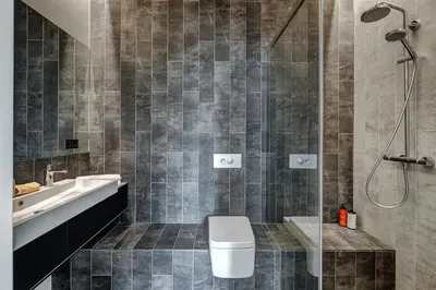 a bathroom with a toilet and a sink and a shower at City Heart One-Bedroom, 15 in Vilnius