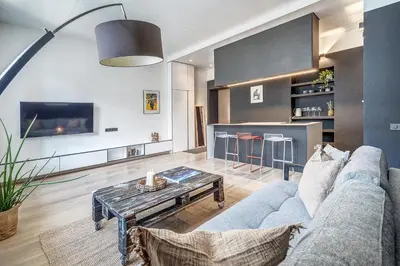 a living room with a blue couch and a table at City Heart One-Bedroom, 15 in Vilnius