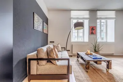 a living room with a couch and a coffee table at City Heart One-Bedroom, 15 in Vilnius