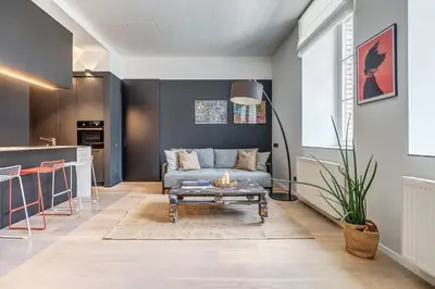a living room with a couch and a table at City Heart One-Bedroom, 15 in Vilnius