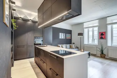 a kitchen with a large island in a room at City Heart One-Bedroom, 15 in Vilnius