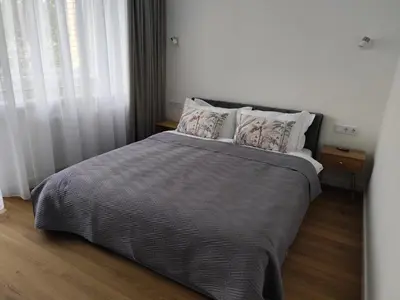 a bedroom with a large bed with two pillows at Stay Rokiškis apartments in Rokiškis