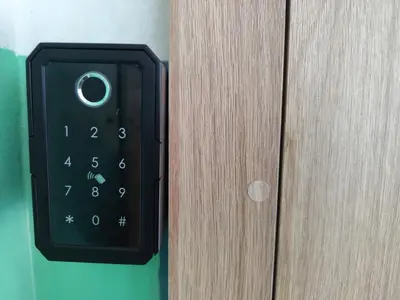 a remote control is attached to a wooden door at Stay Rokiškis apartments in Rokiškis