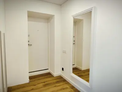 an empty room with a mirror and a hallway at Stay Rokiškis apartments in Rokiškis
