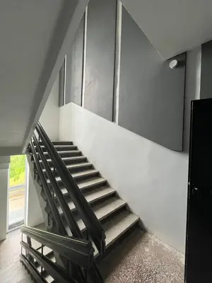 a staircase in a room with a stair case at 1 kambario apartamentai in Raseiniai