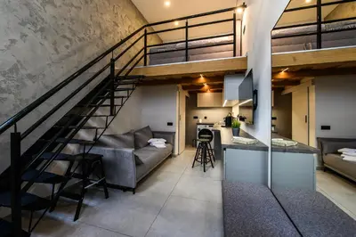 a loft conversion with a staircase and a living room at D-loft in Kaunas