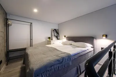 a bedroom with a bed and a large window at D-loft in Kaunas
