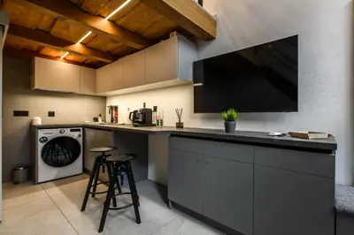a kitchen with a large tv on the wall at D-loft in Kaunas