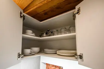 a cupboard with plates and dishes in it at D-loft in Kaunas