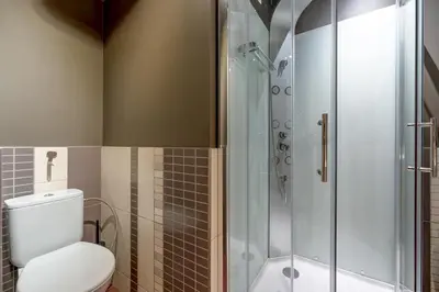 a bathroom with a toilet and a glass shower at SPA apartments in city centre in Vilnius