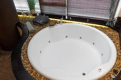 a white sink in a bathroom with a window at SPA apartments in city centre in Vilnius