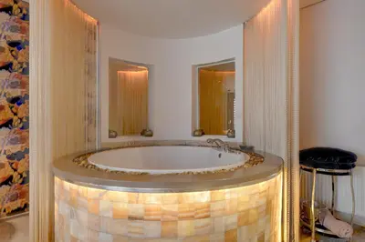 a bathroom with a large tub in a room at SPA apartments in city centre in Vilnius