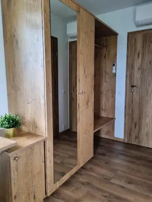 a room with wooden doors and shelves in a room at Kulpe Guest Rooms