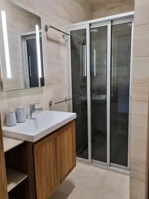 a bathroom with a sink and a shower at Kulpe Guest Rooms