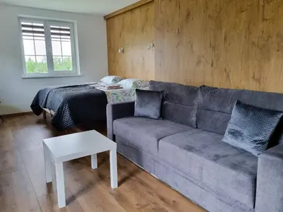 a living room with a couch and a bed at Kulpe Guest Rooms